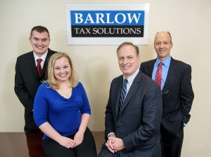 Barlow Team in front of sign